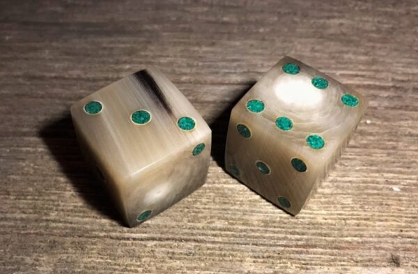 a light colored set of cow horn dice