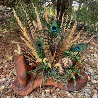 flower arrangement in a wood saddle