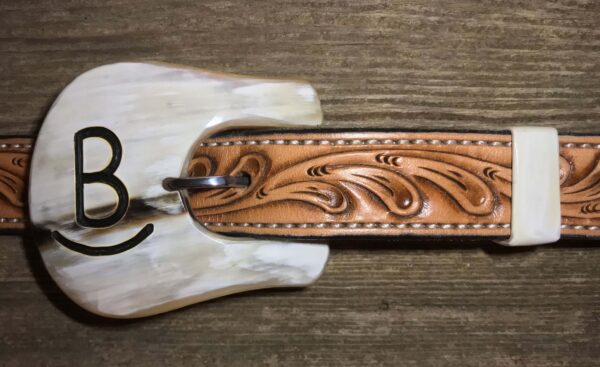 a light color cow horn buckle with inlay