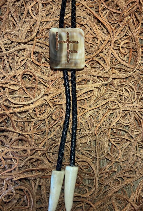 a cow horn bolo tie with inlay