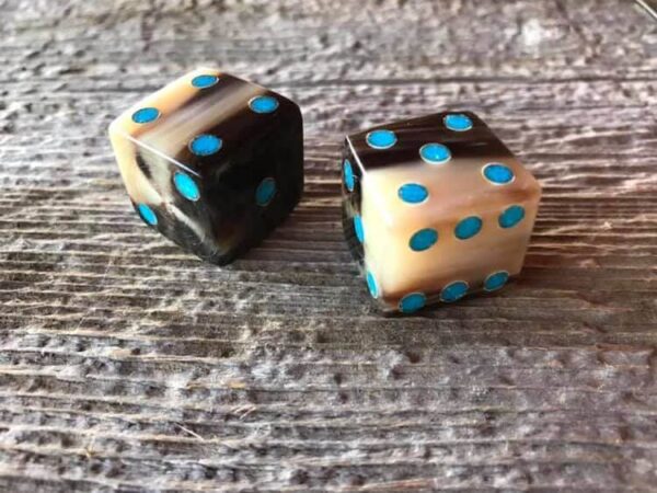 a set of dice with turquoise dots