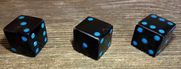 Dark colored cow horn dice with turquoise dots