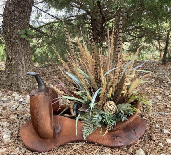 a flower arrangement in a wooden saddle