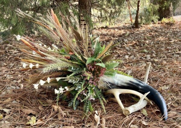 a cow horn flower arrangement with antlers