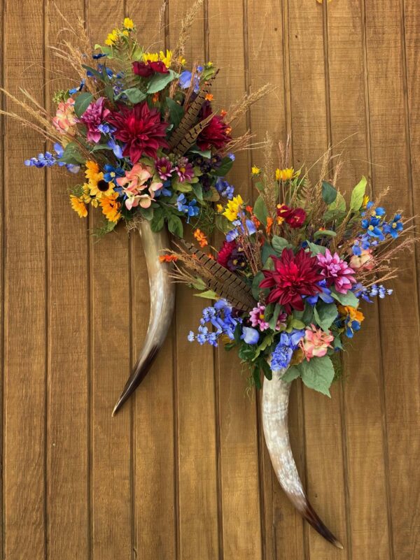 two cow horn flower arrangements