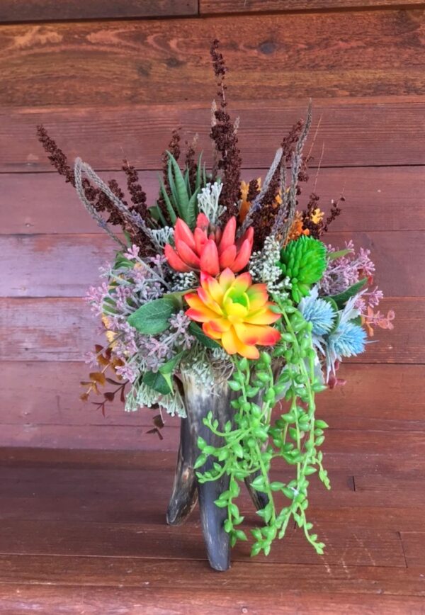 a self standing cow horn flower arrangement