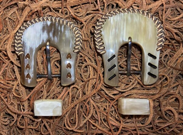 a pair of Headstall Buckles with braids and slashes