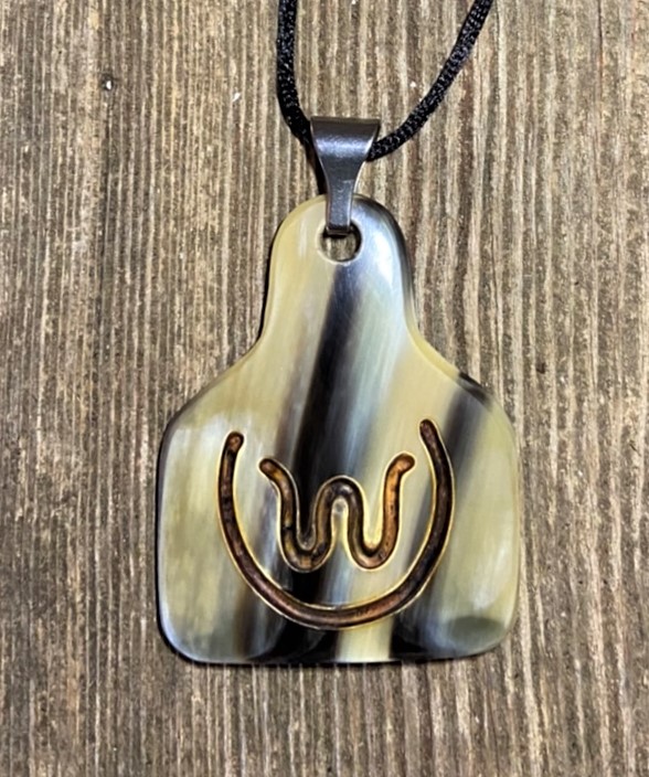 a streaked pendant with copper inlay